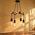Lustre salon vintage bois et métal noir, douille E27 - lustre croix bois devant un mur jaune